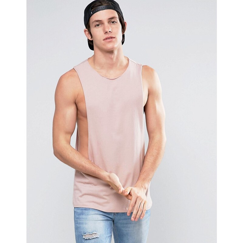 ASOS - T-shirt sans manches à emmanchures ultra larges et bord brut - Rose